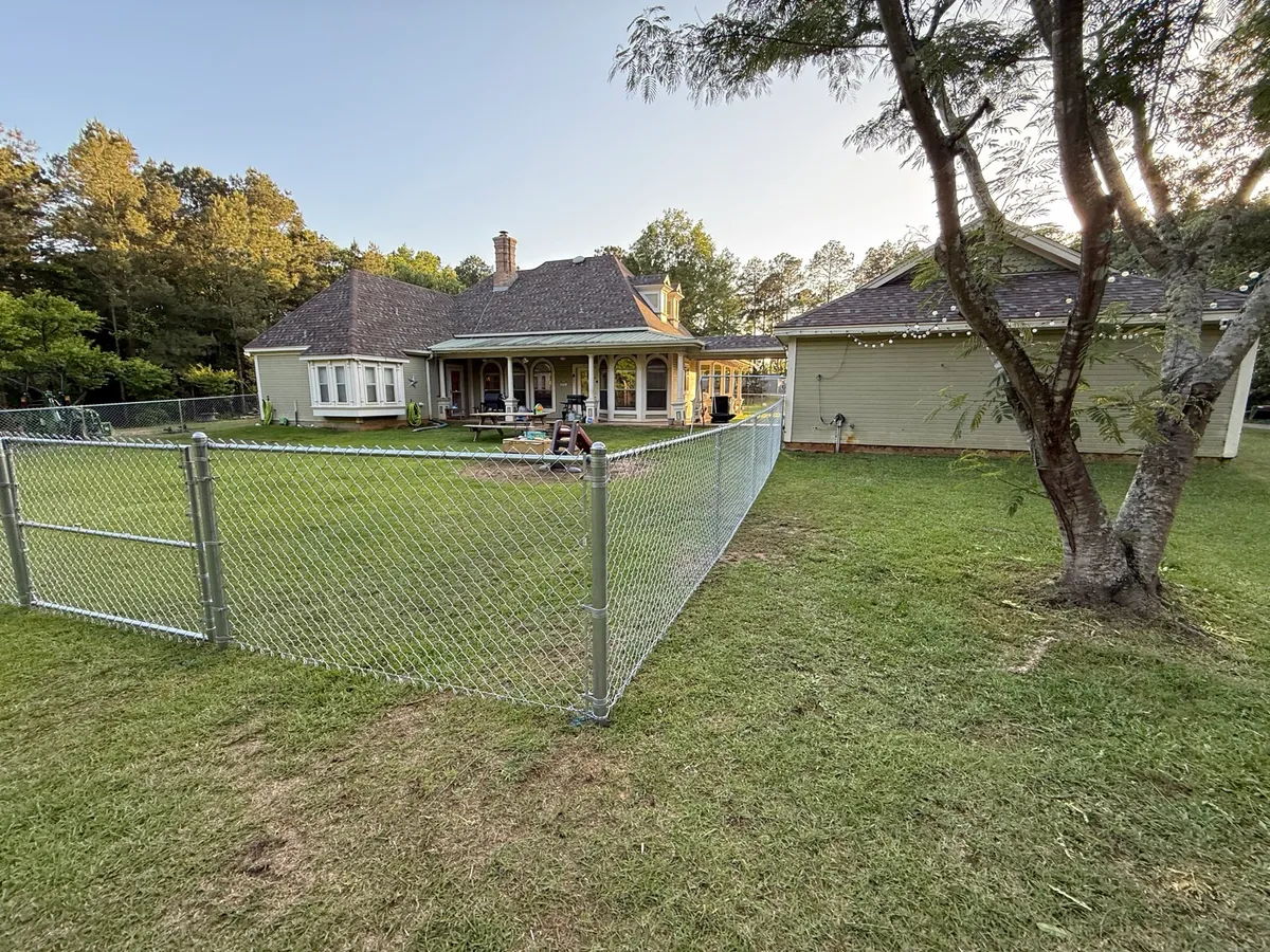 Galvanized chain link enclosing a residential backyard