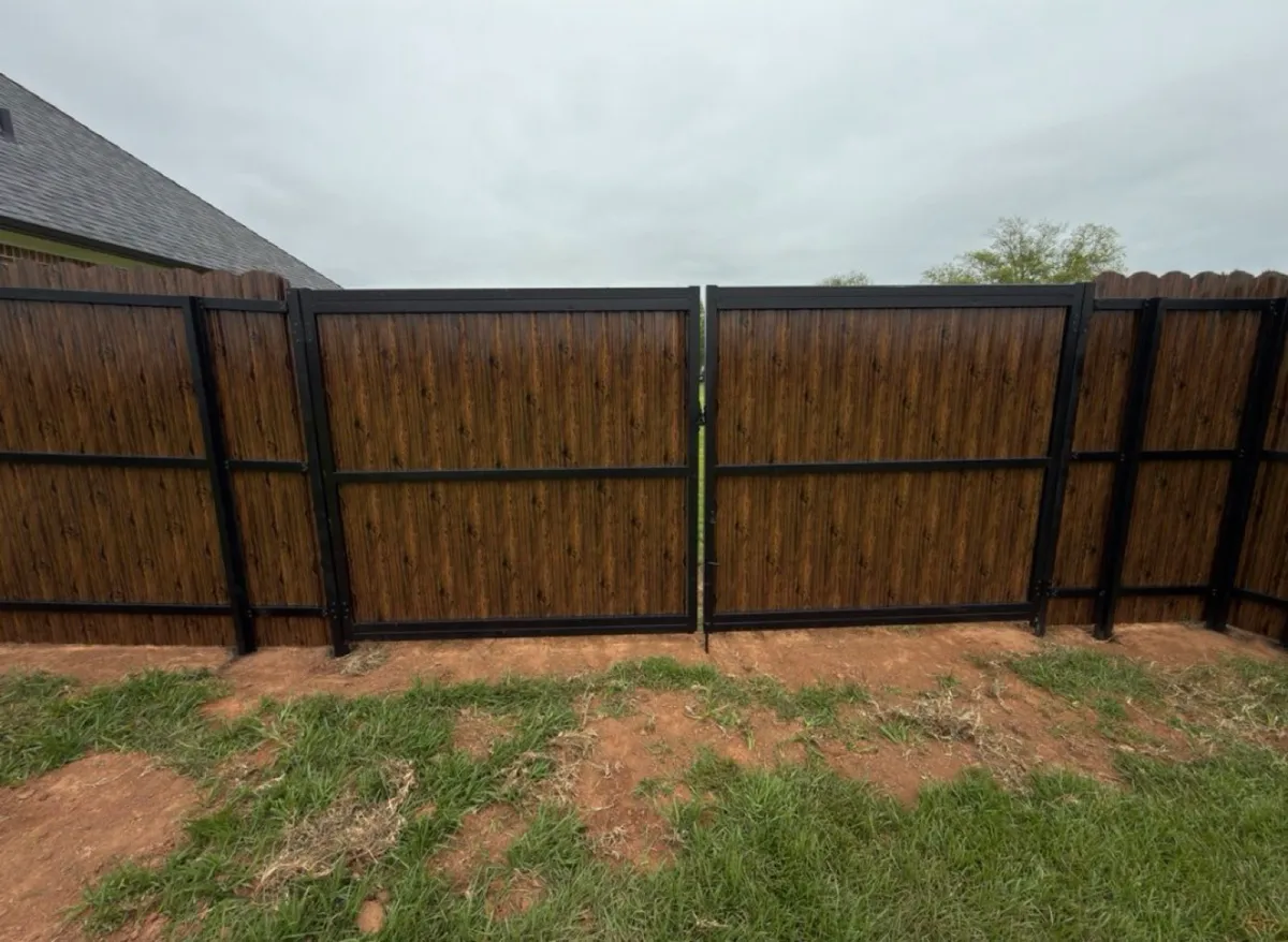 Black-framed double drive gate on a residential lot