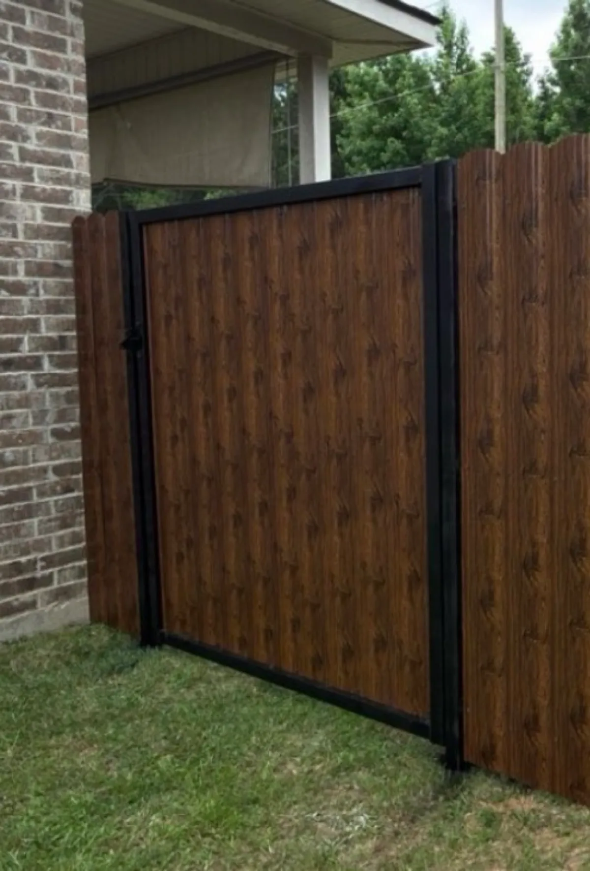 Custom walk gate framed against a brick home