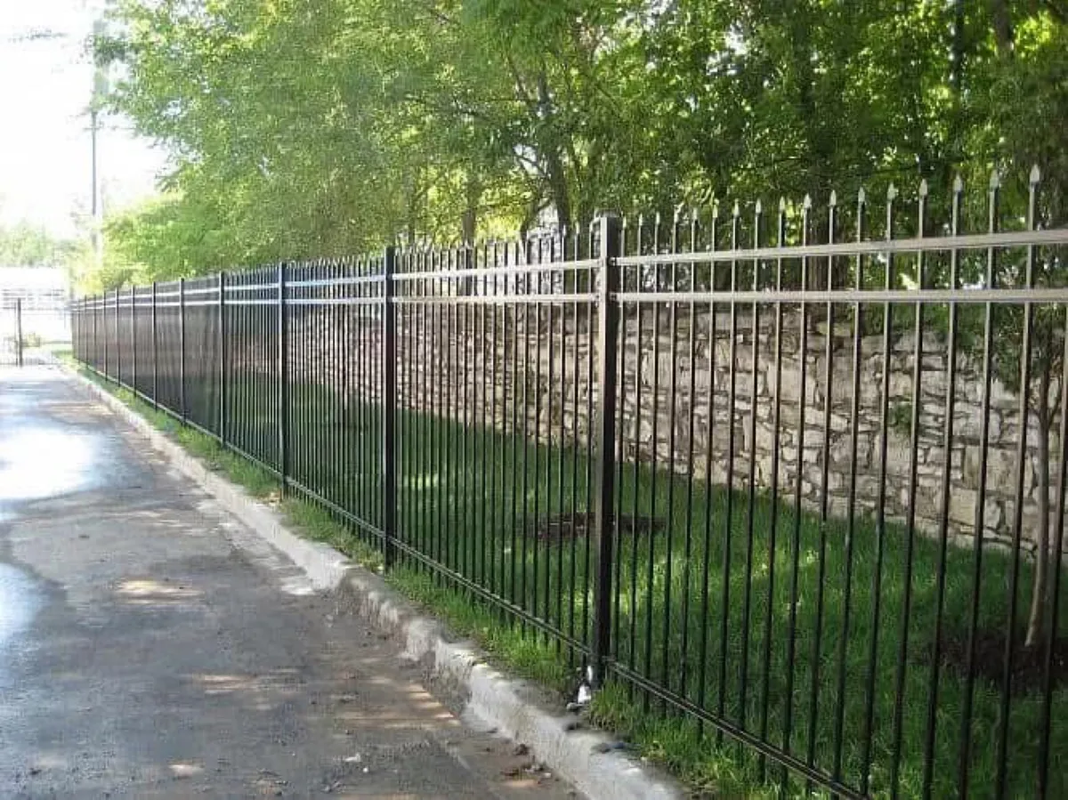 Spear-top ornamental fence running along a street frontage