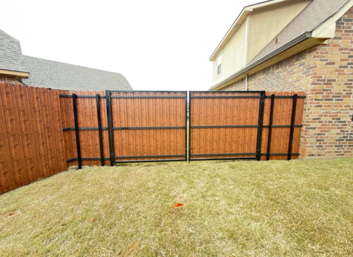 Steel privacy fence with a matching double drive gate