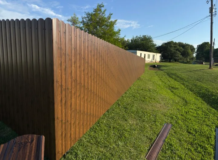 Scalloped-top steel privacy on a sloped yard: steel privacy fence in Holden service area