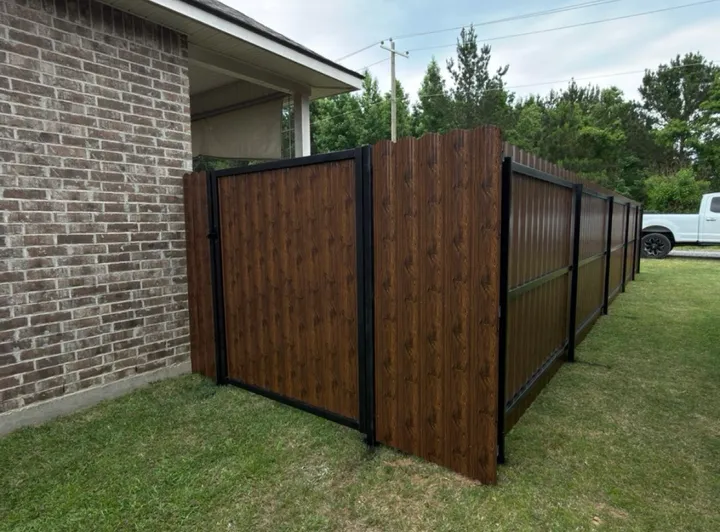 Dark steel privacy tied into brick: steel privacy fence in Holden service area