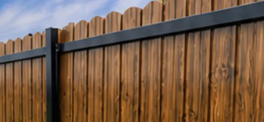 Six-foot wood privacy fence with cedar pickets and a straight top line